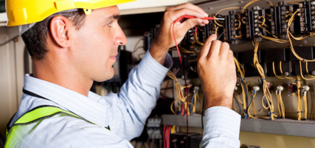 electrician testing industrial machine